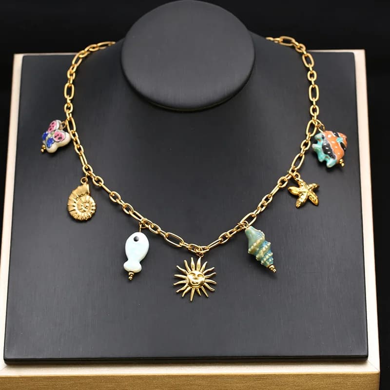 Gouden hangerketting met zeester, schelp en zon