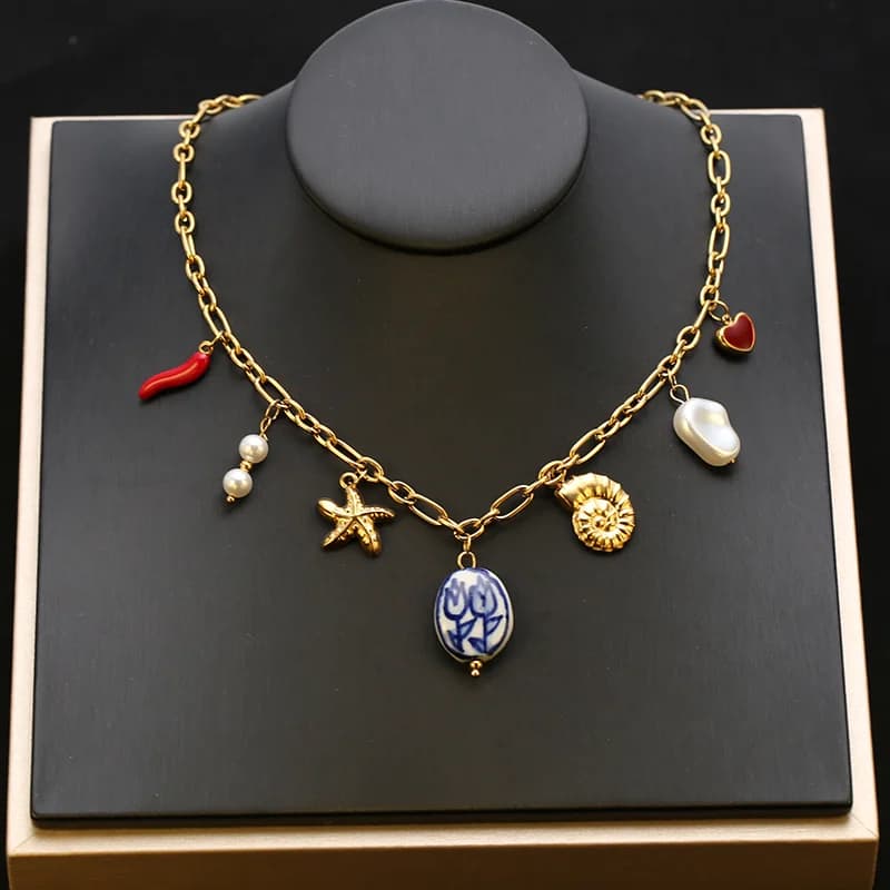 Gouden hangerketting met zeester, schelp en zon