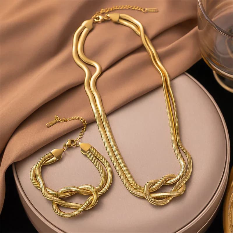 Goudkleurige knoopketting halsband en armband set
