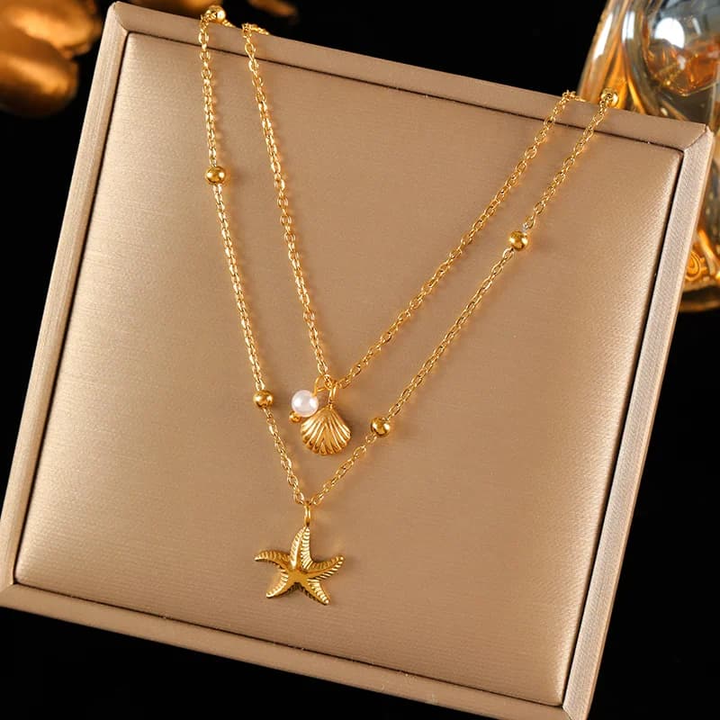 Ketting met dubbele ketting, zeesterren- en schelpbedels, goud